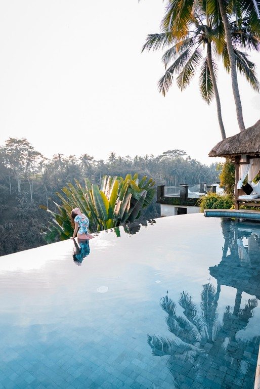 Girl sitting by the poolside at The Viceroy Bali 
