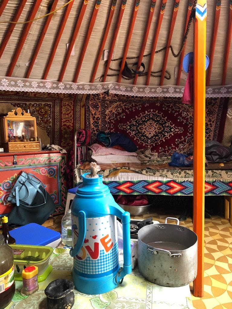 Inside a traditional Mongolian Yurt where carpets hang for insolation 