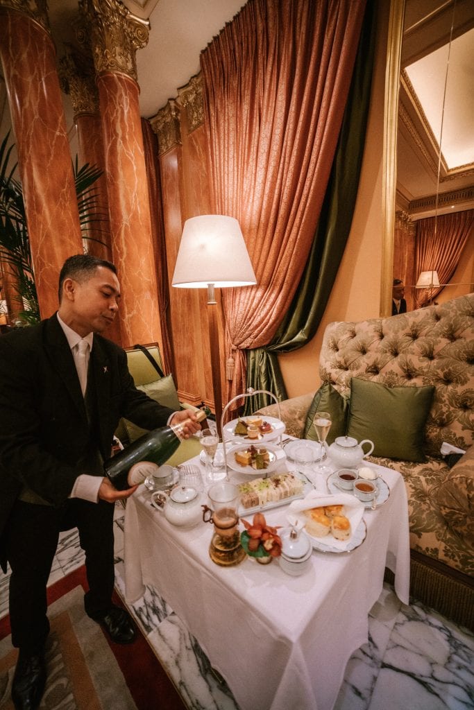 Waiter pouring champagne at the Dorchester Hotel London